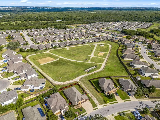 an aerial view of residential houses with outdoor space