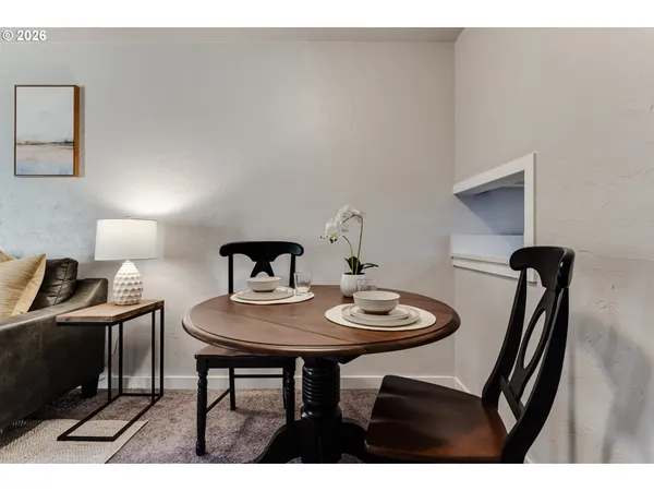 a living room with furniture a fireplace and a large window