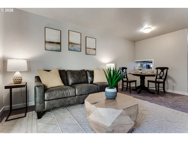 a living room with furniture a fireplace and a potted plant