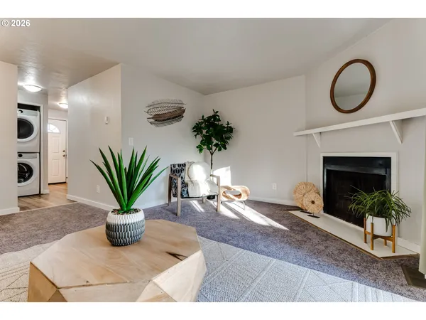 a living room with furniture a window and a fireplace