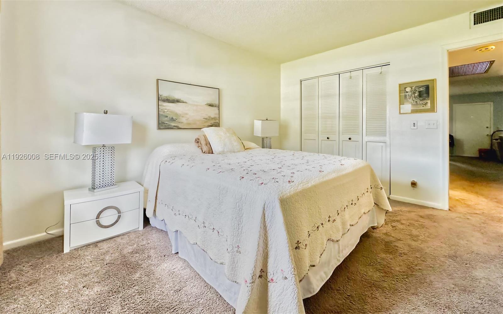 150 Southwest 134th Way, Unit 203R Pembroke Pines, FL 33027 - Photo 13 of 30 a bedroom with a bed and a lamp