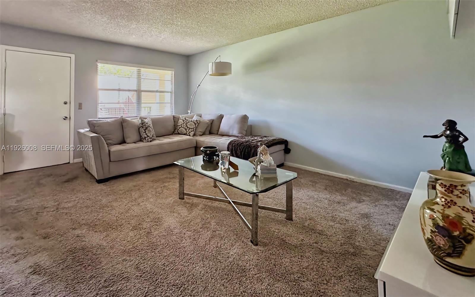 150 Southwest 134th Way, Unit 203R Pembroke Pines, FL 33027 - Photo 18 of 30 a living room with furniture and a window