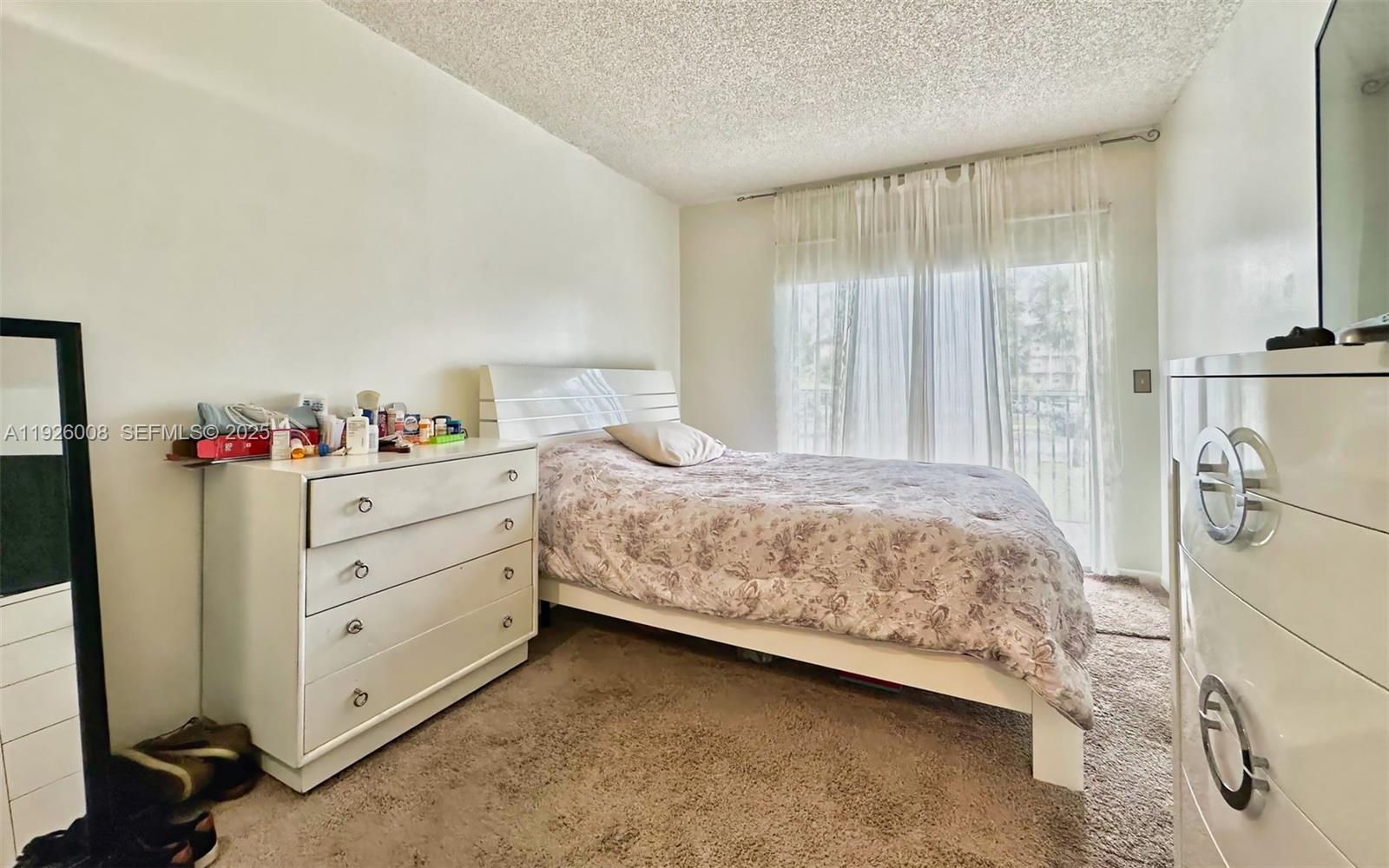 150 Southwest 134th Way, Unit 203R Pembroke Pines, FL 33027 - Photo 20 of 30 a bedroom with a bed and a window