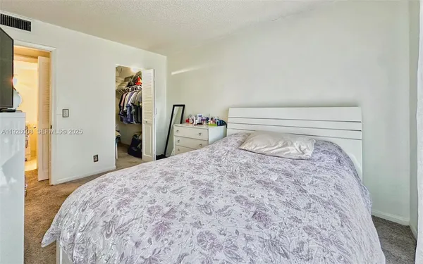 a bedroom with a bed and a closet