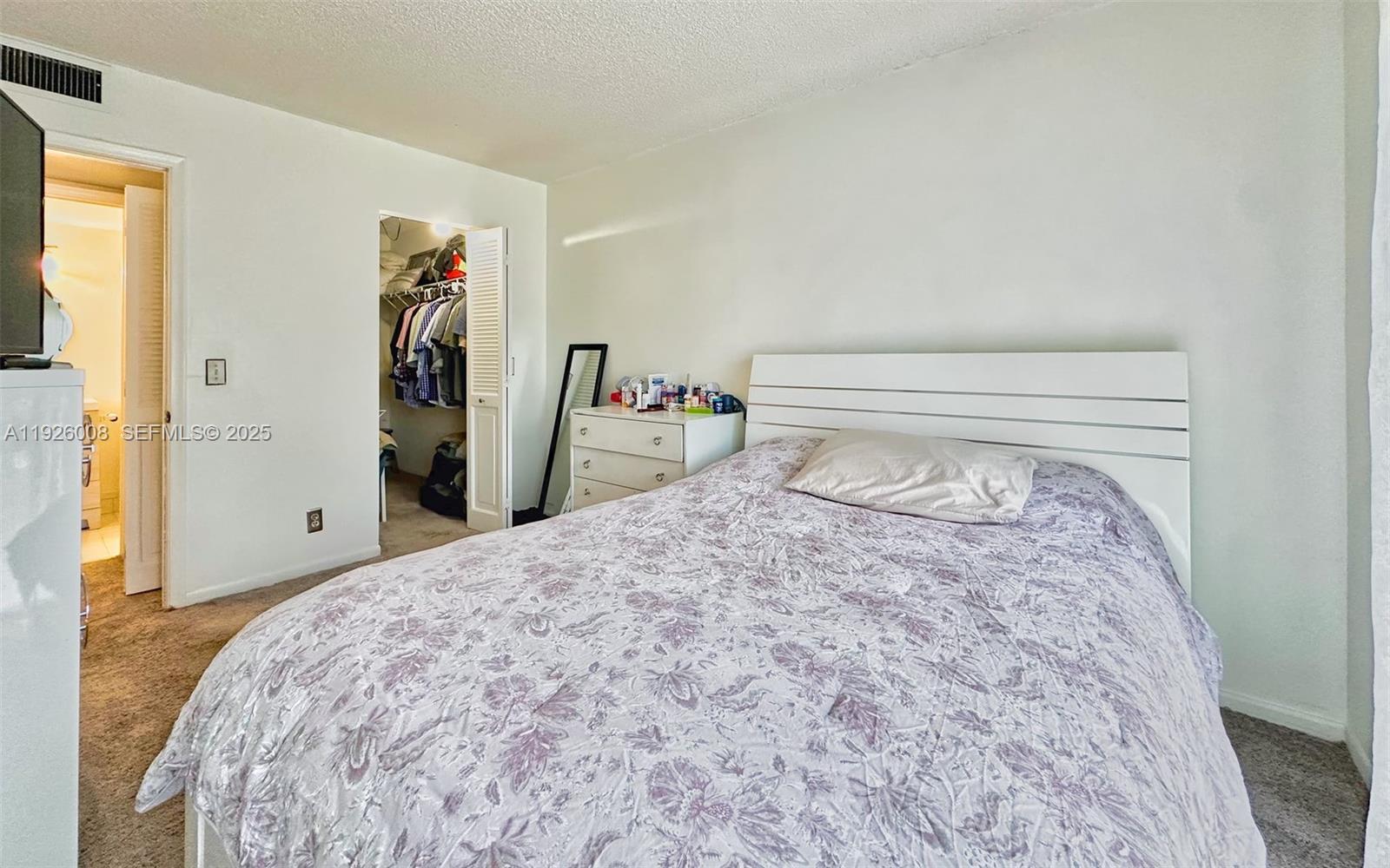 150 Southwest 134th Way, Unit 203R Pembroke Pines, FL 33027 - Photo 21 of 30 a bedroom with a bed and a closet