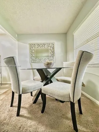 a living room with chairs and a table