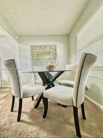 a living room with chairs and a table