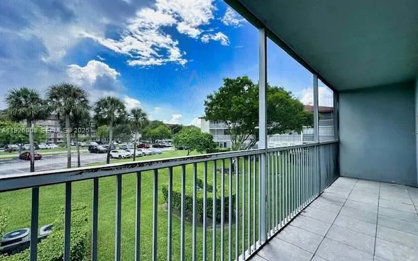 a view of a balcony with a plants and trees