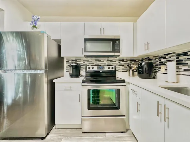 a view of a dining room with furniture and a window