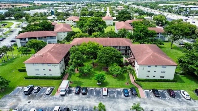 an aerial view of house with garden space and street view