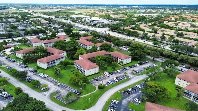 an aerial view of residential houses with outdoor space