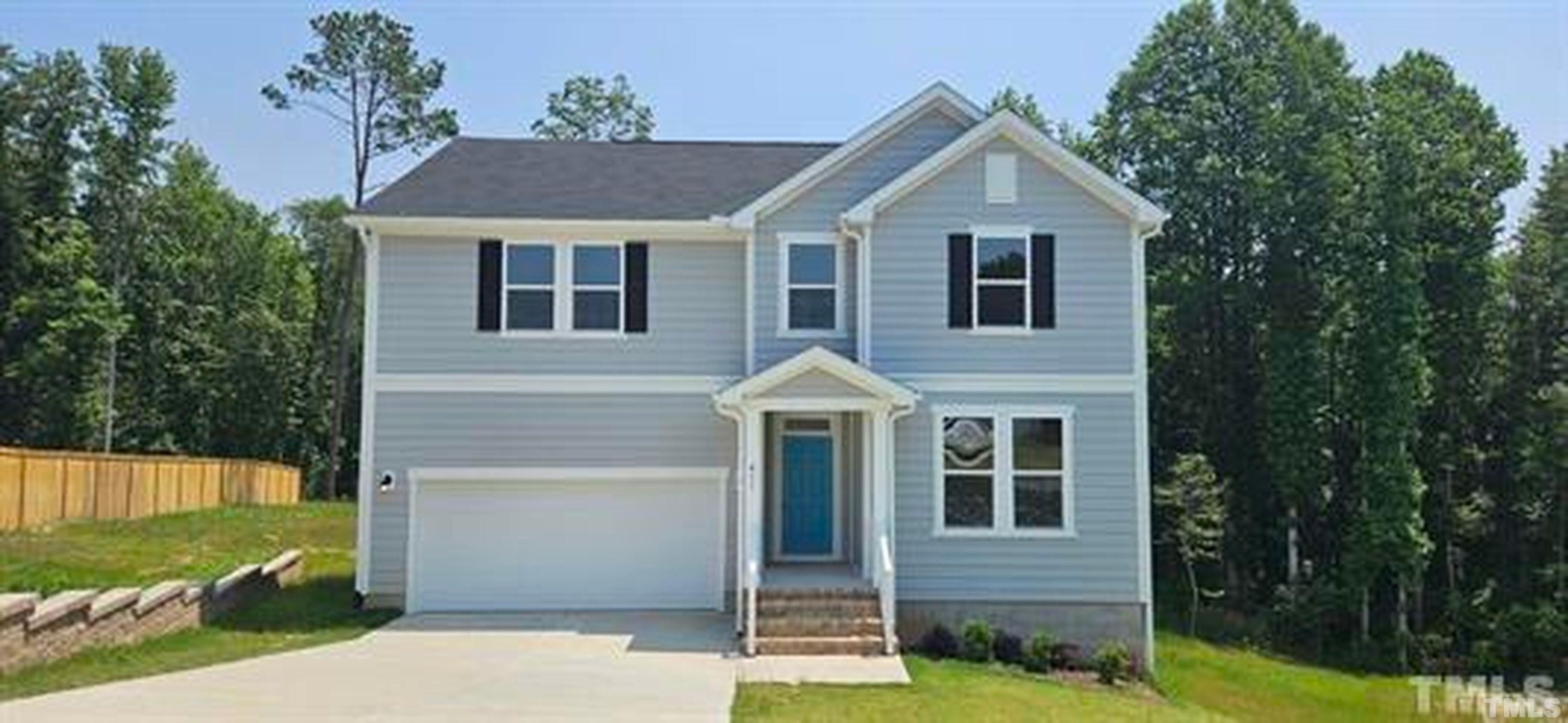 411 Rio Grande Lane Willow Spring, NC 27592 - Photo 1 of 29 a front view of a house with garden