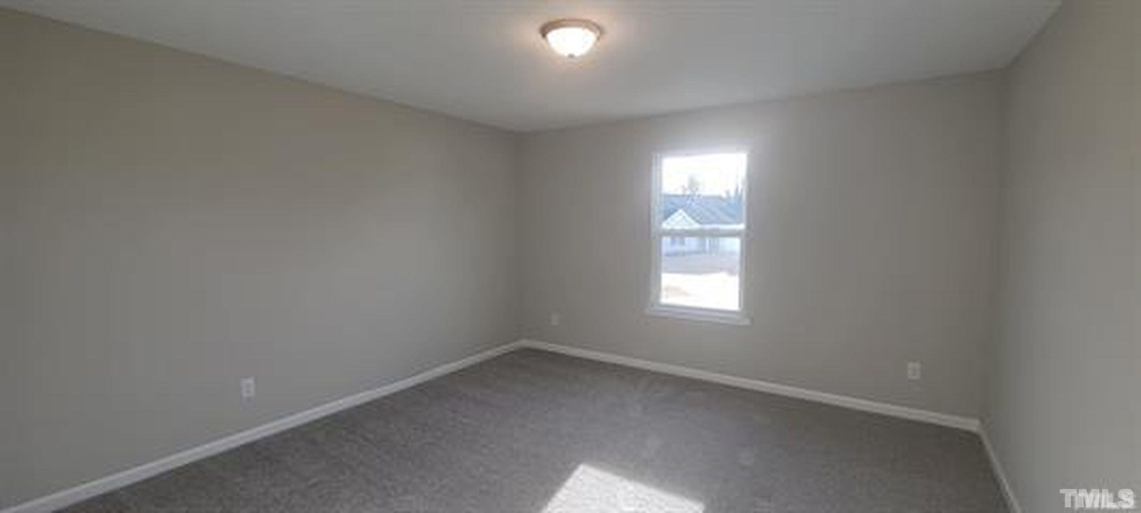 411 Rio Grande Lane Willow Spring, NC 27592 - Photo 13 of 29 an empty room with a window