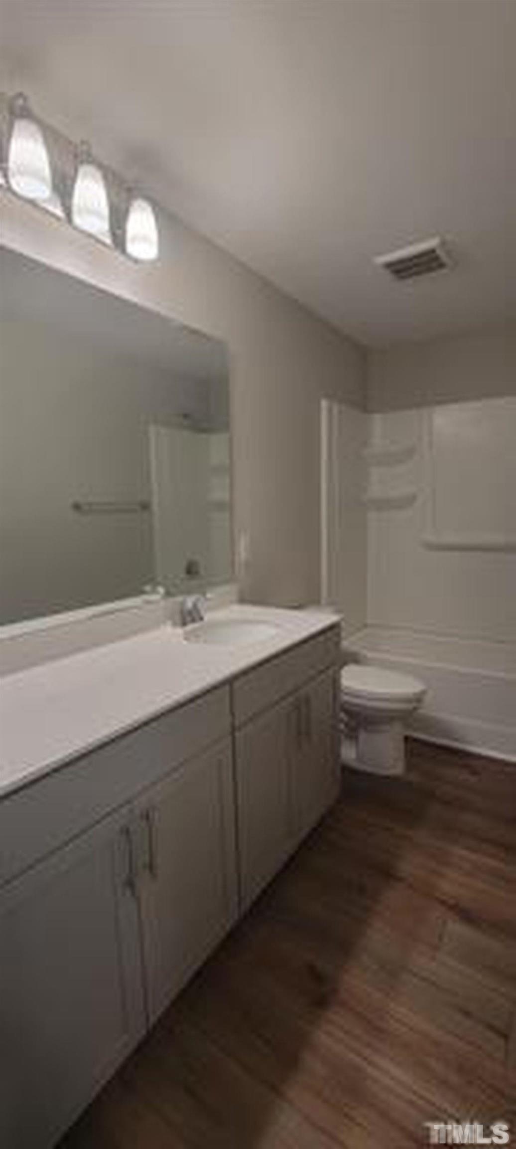 411 Rio Grande Lane Willow Spring, NC 27592 - Photo 15 of 29 a bathroom with a double vanity sink toilet and a mirror