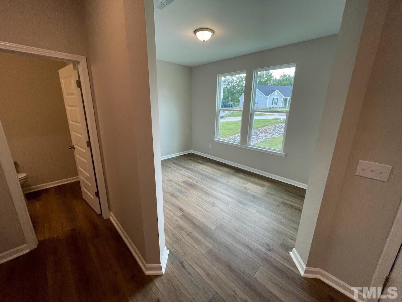 411 Rio Grande Lane Willow Spring, NC 27592 - Photo 2 of 29 wooden floor in an empty room with a window