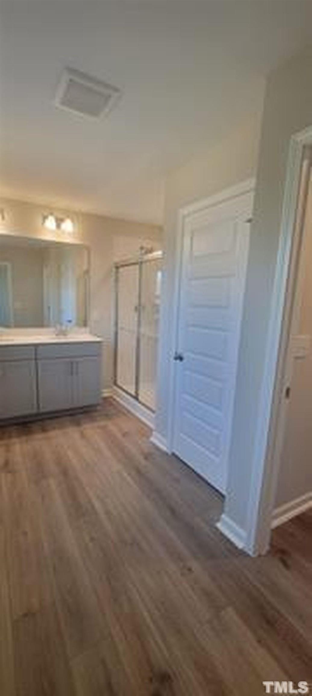411 Rio Grande Lane Willow Spring, NC 27592 - Photo 21 of 29 an empty room with wooden floor and cabinet