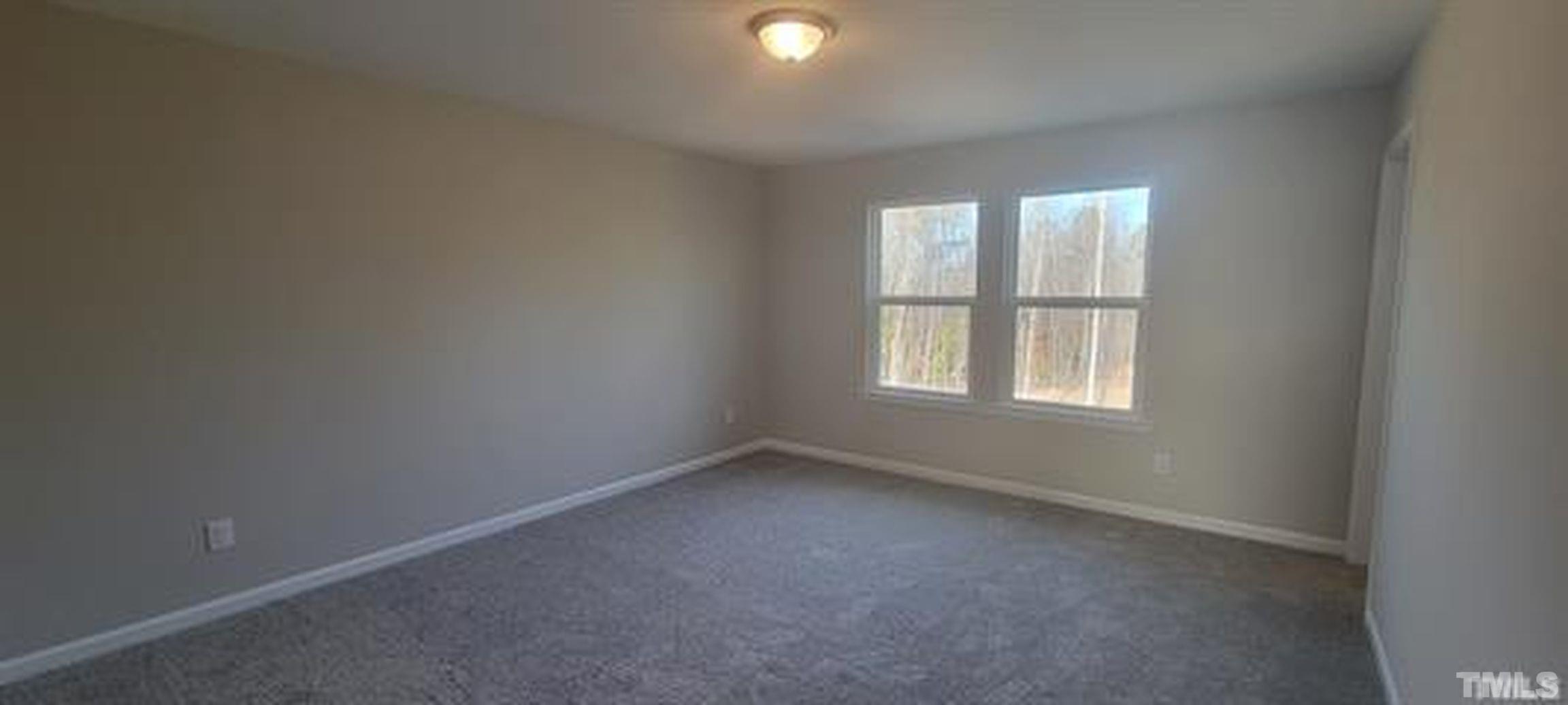 411 Rio Grande Lane Willow Spring, NC 27592 - Photo 22 of 29 an empty room with windows and closet