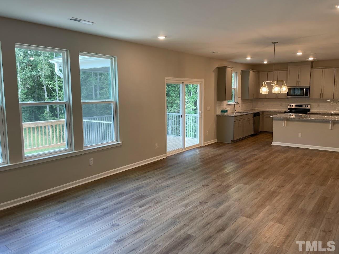 411 Rio Grande Lane Willow Spring, NC 27592 - Photo 4 of 29 a view of large kitchen with a sink and wooden floor
