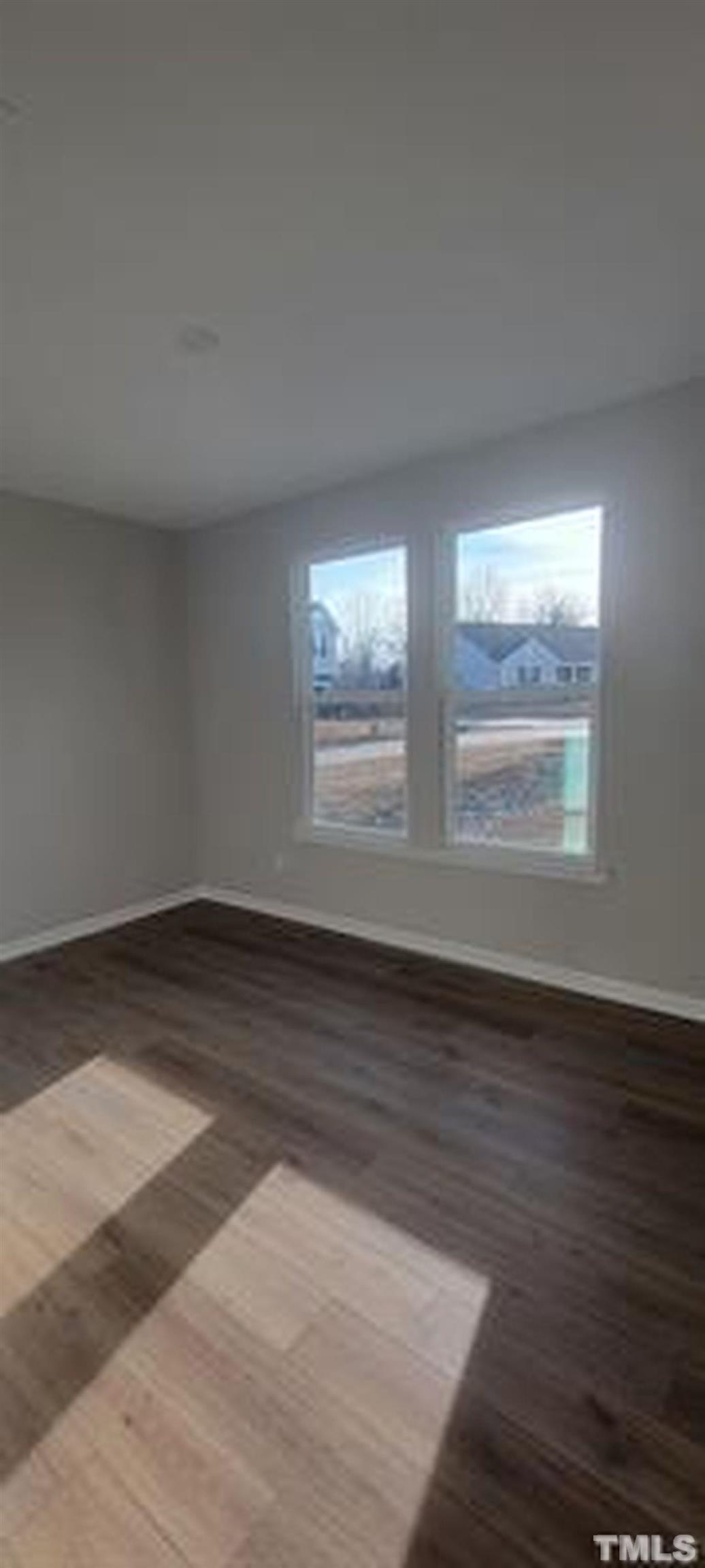 411 Rio Grande Lane Willow Spring, NC 27592 - Photo 5 of 29 an empty room with wooden floor and windows