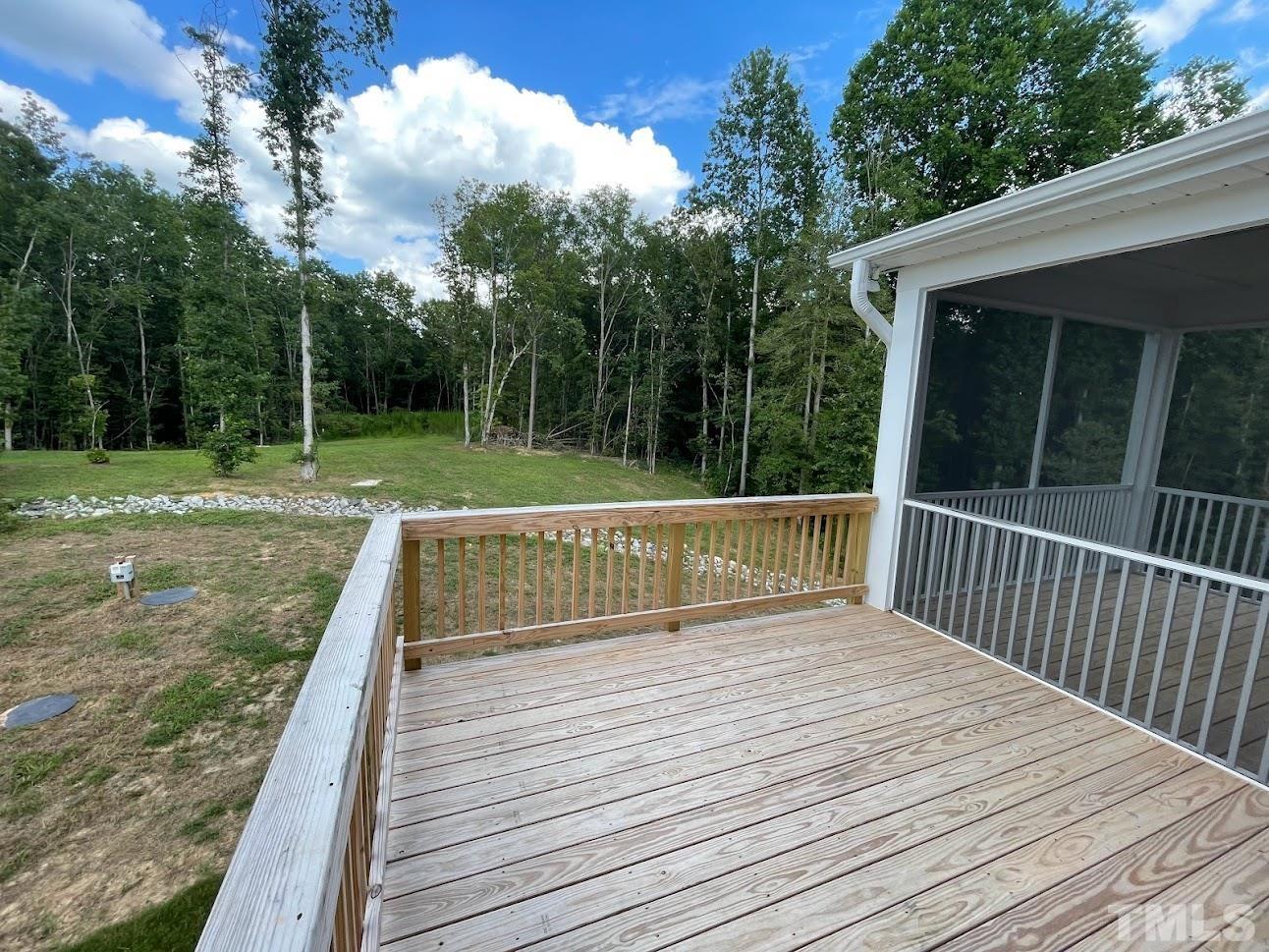 411 Rio Grande Lane Willow Spring, NC 27592 - Photo 10 of 29 a view of a deck with a yard and wooden fence