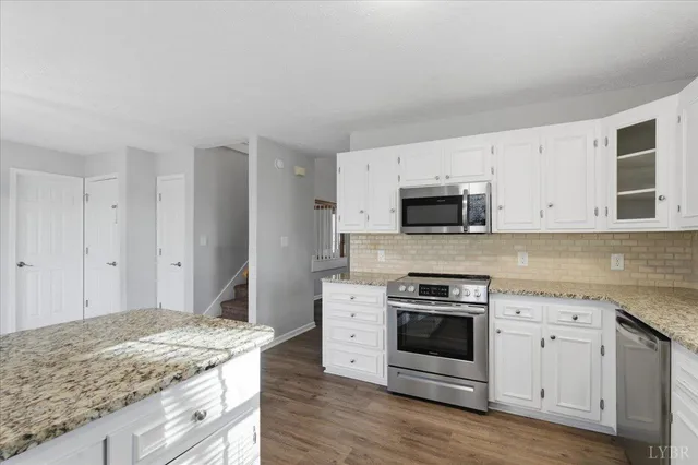 a stove top oven sitting inside of a kitchen