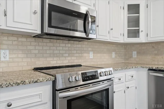 a kitchen with granite countertop a sink and cabinets