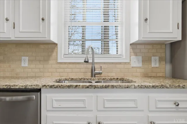 a kitchen with stainless steel appliances granite countertop a refrigerator and a stove