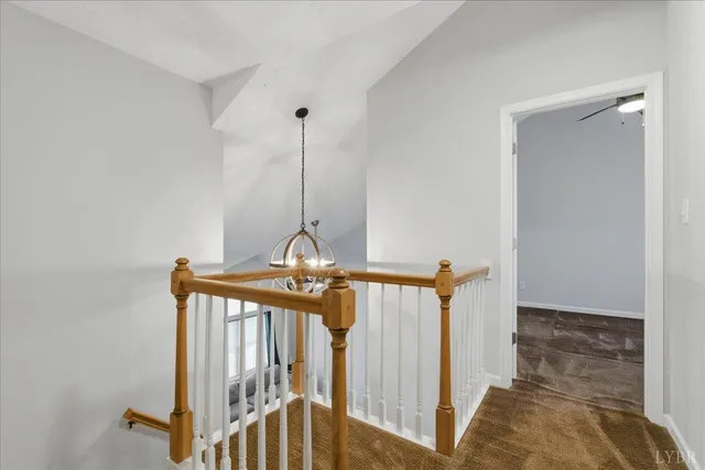 an empty room with ceiling fan and window
