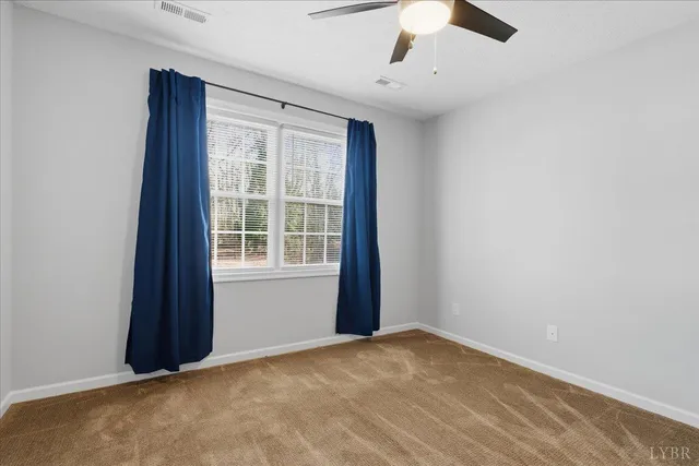 an empty room with a empty space and a ceiling fan