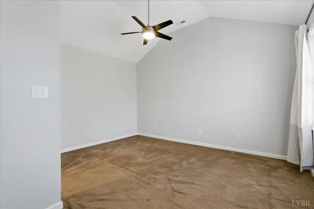 a bathroom with a granite countertop sink a toilet and a mirror