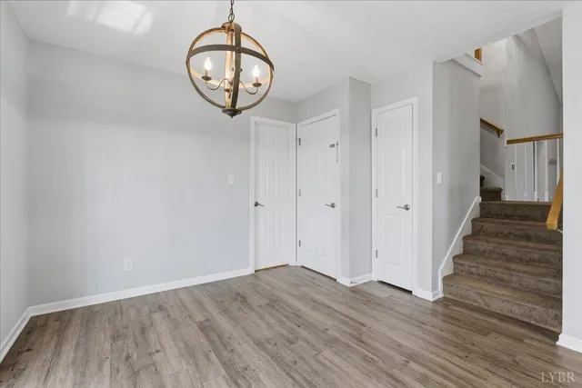 a view of a room with wooden floor and white walls