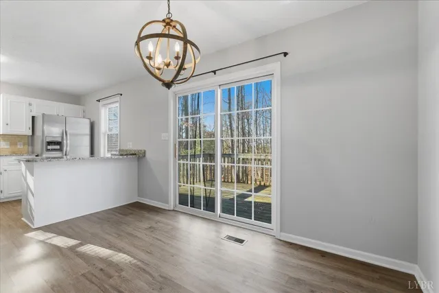 a view of a kitchen with wooden floor and a window
