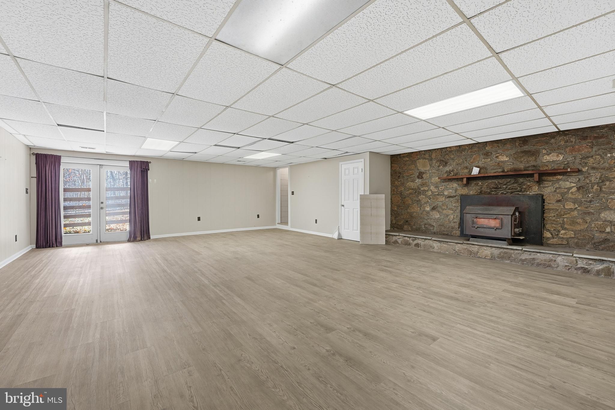 4431 Ringwood Road Nokesville, VA 20181 - Photo 12 of 14 an empty room with fireplace and window