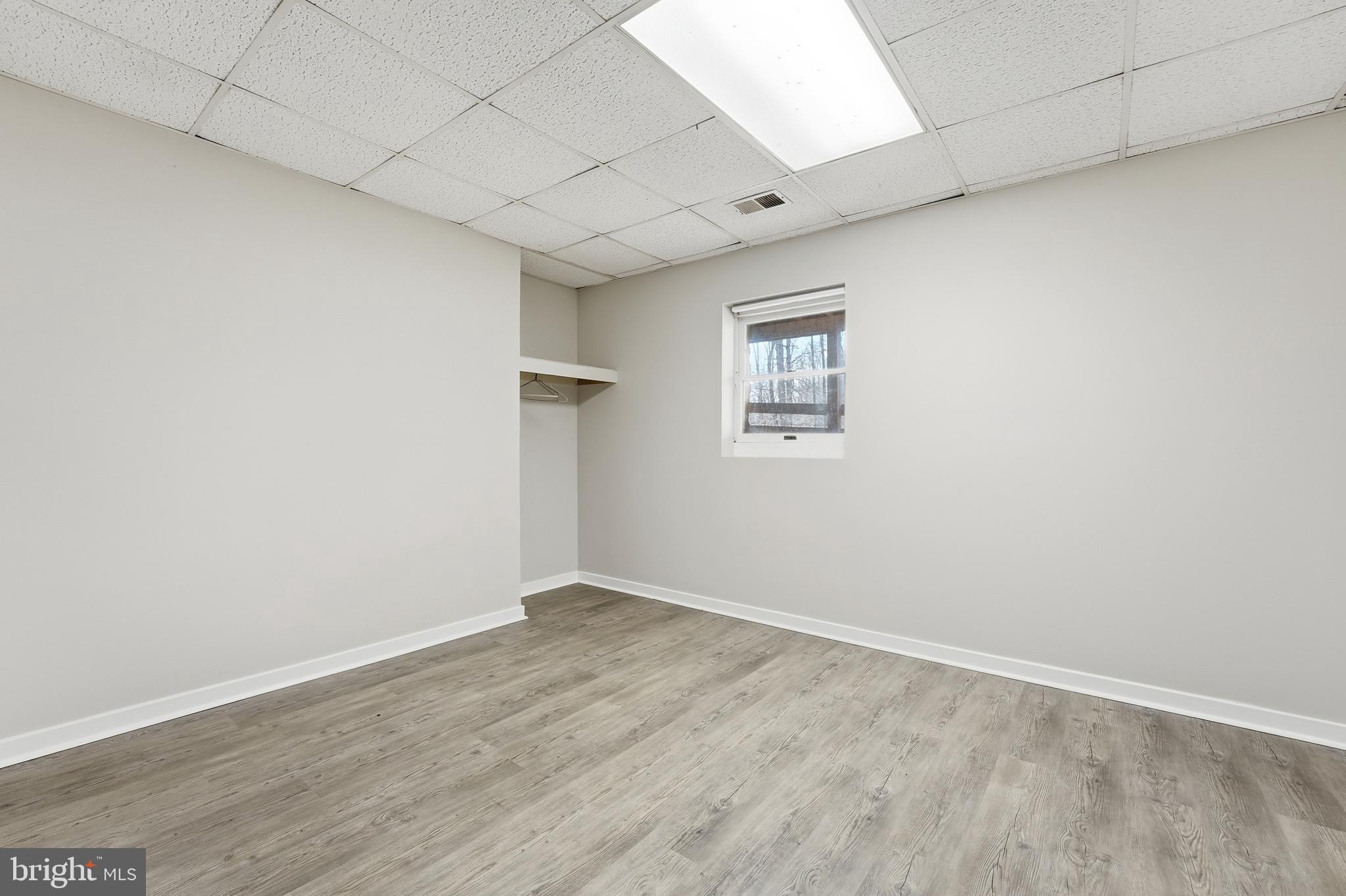 4431 Ringwood Road Nokesville, VA 20181 - Photo 13 of 14 an empty room with wooden floor and windows