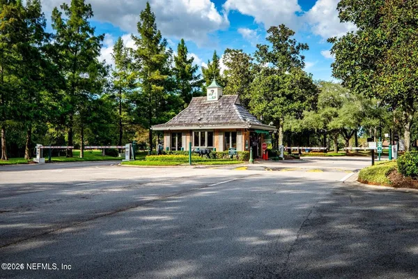 a view of pool with umbrella and trees in the background