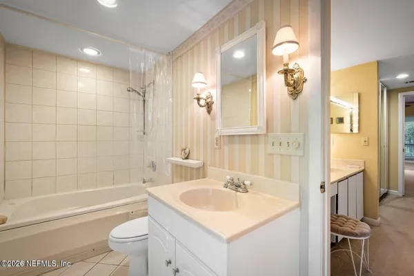 a bathroom with a sink toilet vanity and shower