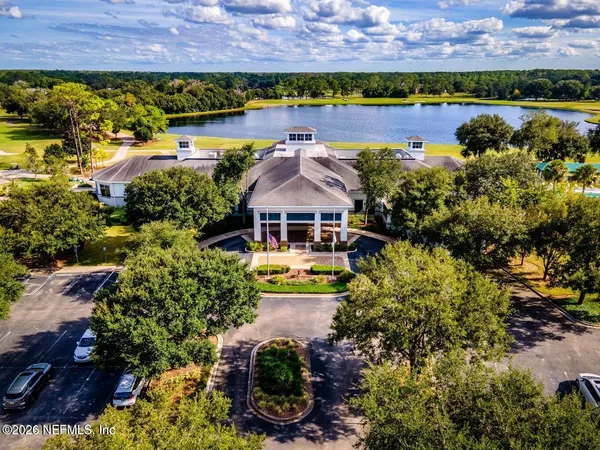 an aerial view of a house with a garden and lake view