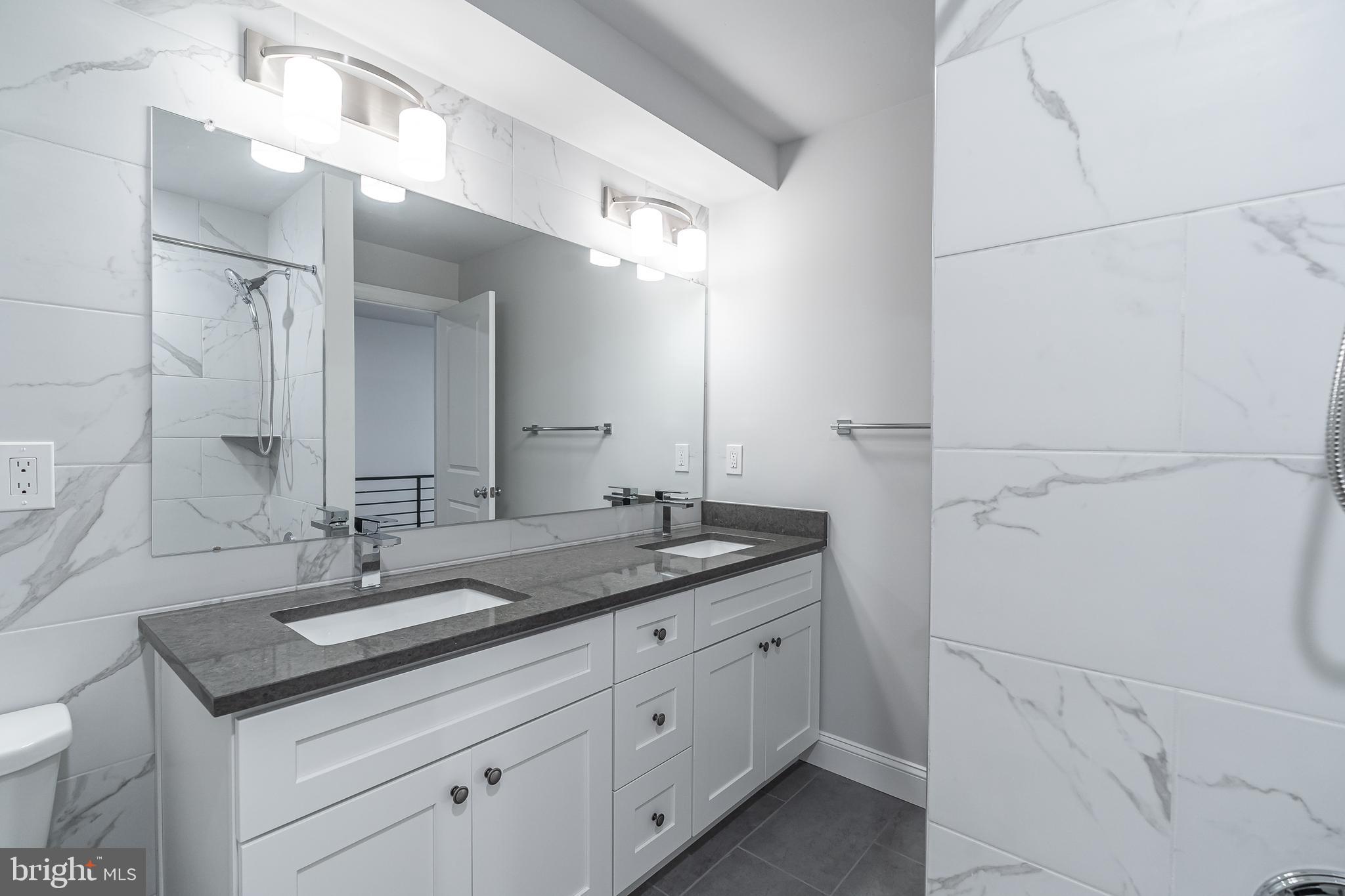 2202 Christian Street, Unit 1 Philadelphia, PA 19146 - Photo 11 of 27 a bathroom with a sink and a mirror