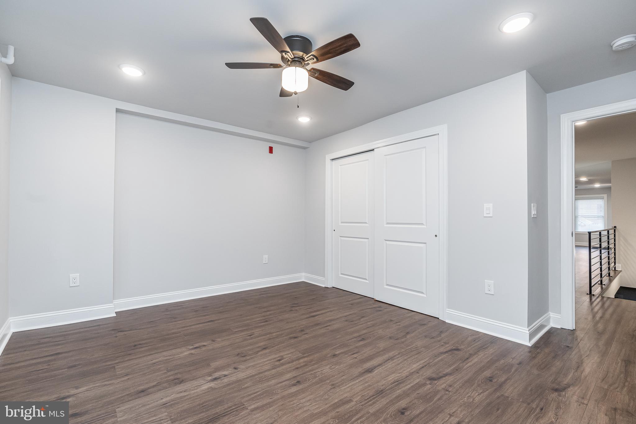 2202 Christian Street, Unit 1 Philadelphia, PA 19146 - Photo 14 of 27 an empty room with wooden floor and ceiling fan