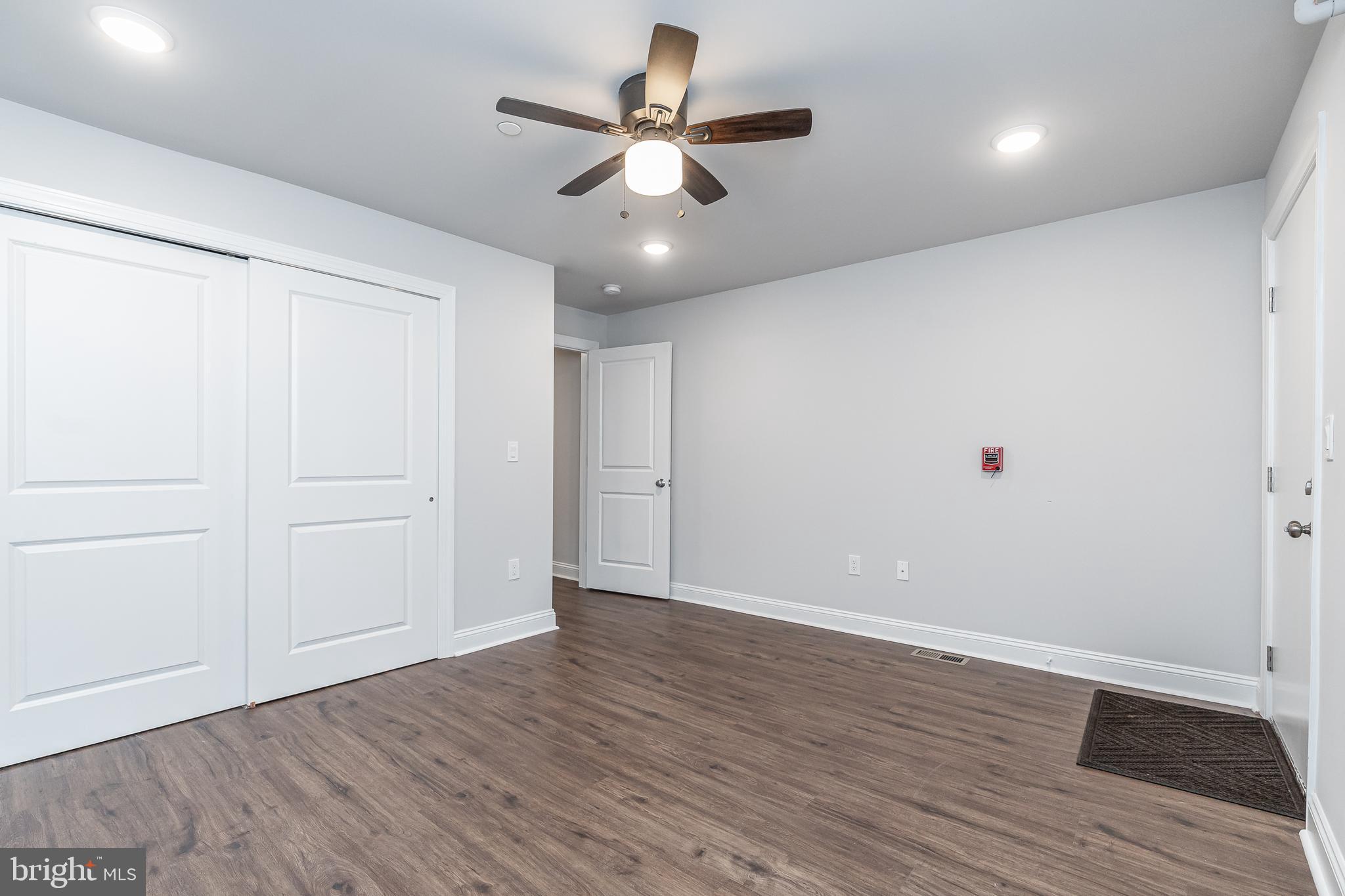 2202 Christian Street, Unit 1 Philadelphia, PA 19146 - Photo 15 of 27 an empty room with wooden floor and windows