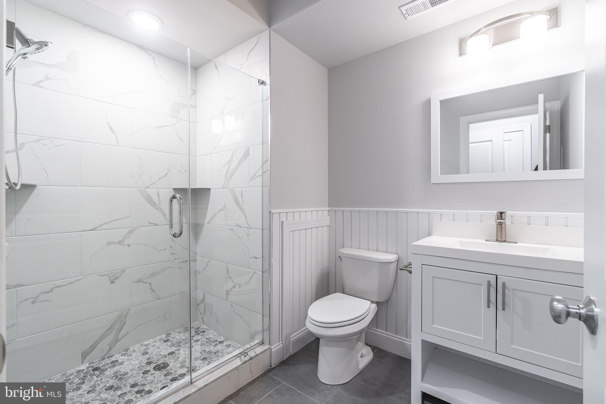 2202 Christian Street, Unit 1 Philadelphia, PA 19146 - Photo 21 of 27 a bathroom with a toilet sink and shower