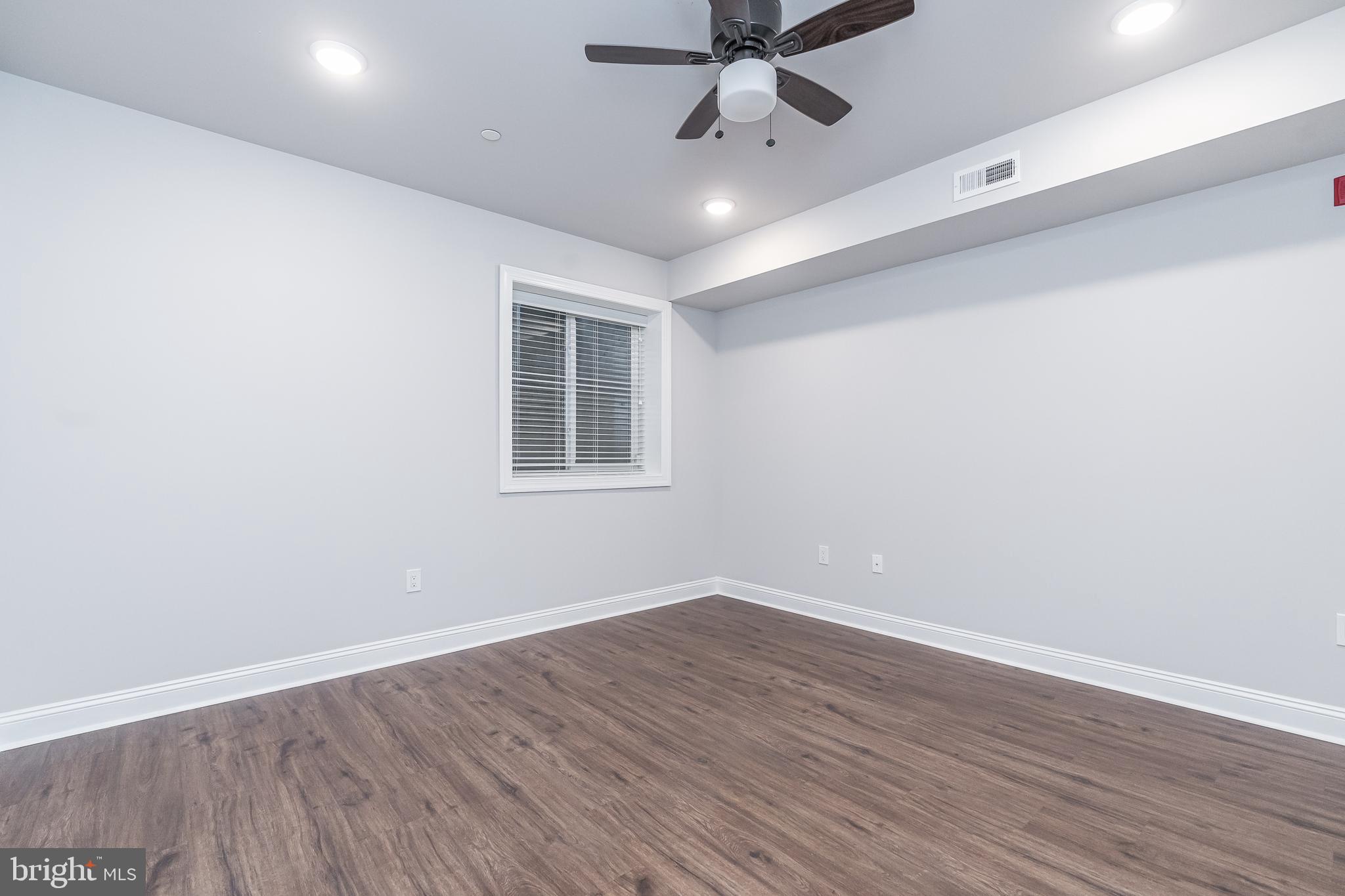 2202 Christian Street, Unit 1 Philadelphia, PA 19146 - Photo 24 of 27 a view of a room with wooden floor and windows