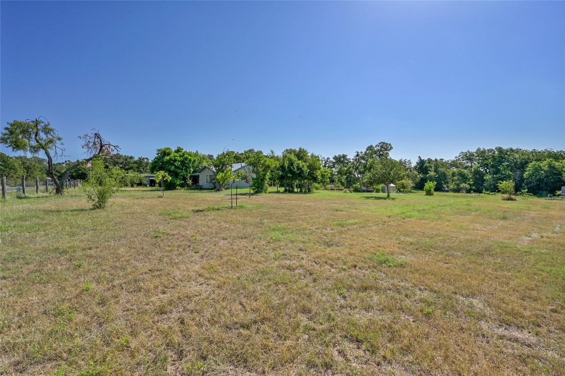 681 County Road 474 Elgin, TX 78621 - Photo 21 of 37 a view of a garden with a building in the background