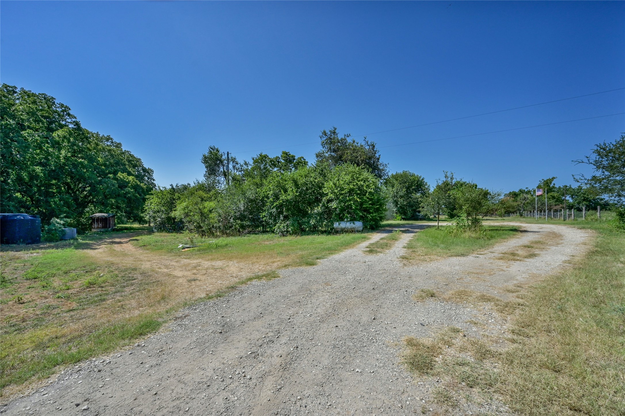 681 County Road 474 Elgin, TX 78621 - Photo 22 of 37 a view of a lake with a big yard
