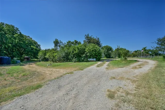 a view of a garden with a building in the background