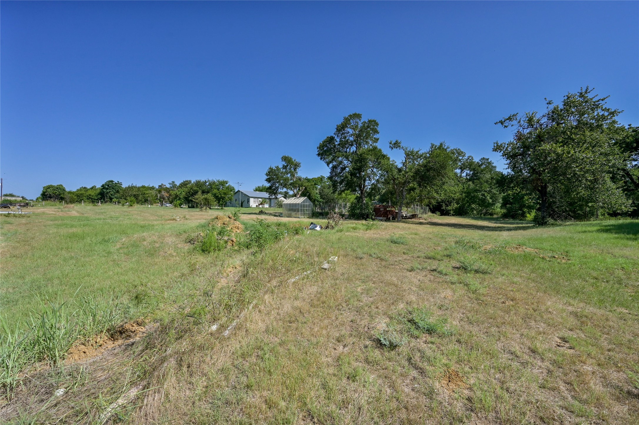 681 County Road 474 Elgin, TX 78621 - Photo 33 of 37 a view of a grassy field with trees in the background