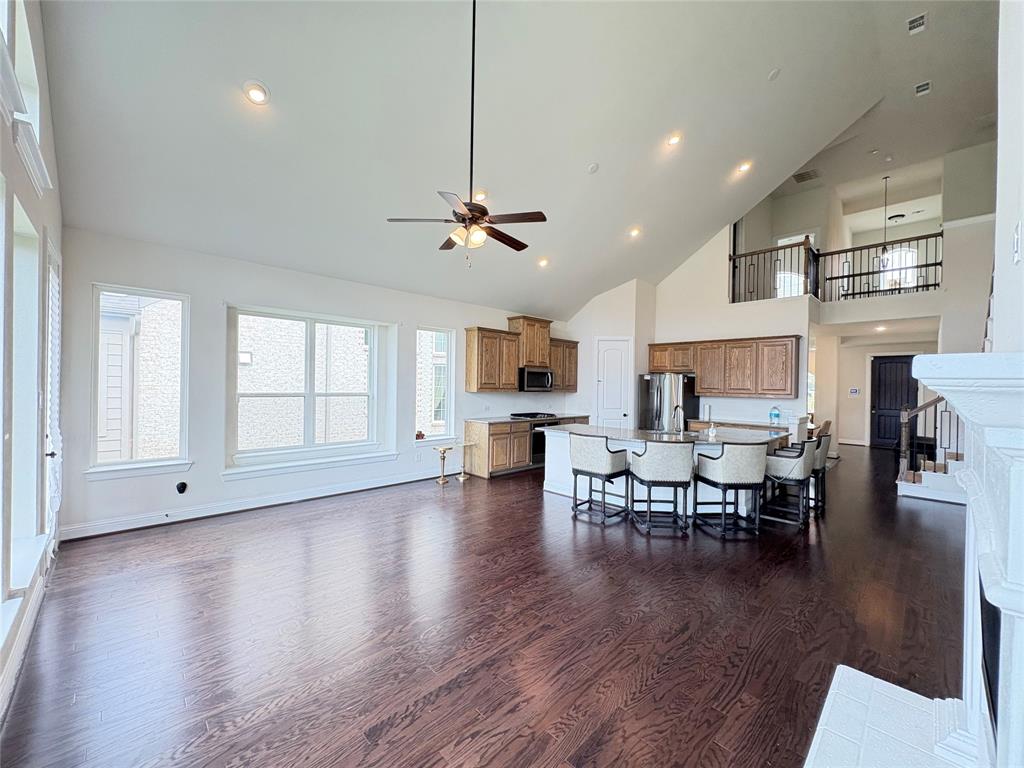 323 Butternut Way Irving, TX 75063 - Photo 7 of 32 an open kitchen with white cabinets and outdoor seating