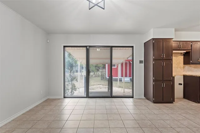 a kitchen with stainless steel appliances a refrigerator and microwave