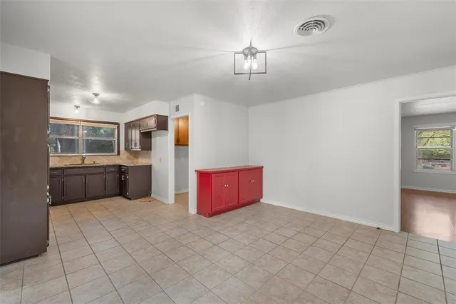 a kitchen with granite countertop cabinets sink and window