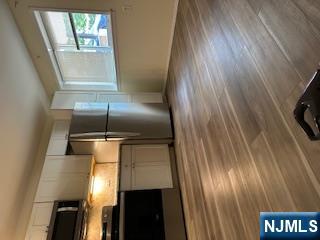 334 Grand Avenue, Unit 10 Leonia, NJ 07605 - Photo 2 of 10 a view of a kitchen with wooden floor and electronic appliances